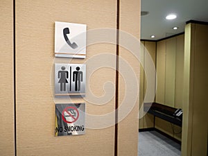 Men and women toilet signs on a green wall