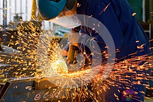 Men at work grinding steel photo