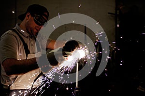 Men at work grinding steel