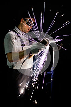 Men at work grinding steel photo