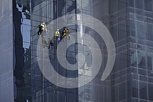 Men at work cleaning the facade of a skyscaper