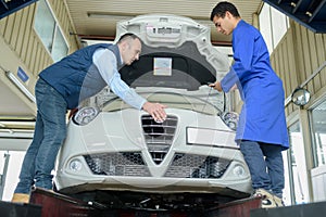 Men working on car on production line