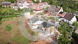 Men working at construction site, building new house cottage, installing windows