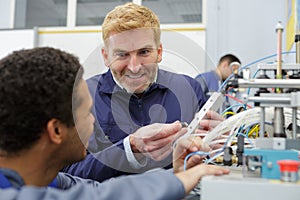 men working in electronics factory