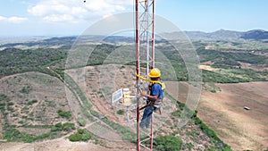men working in meteorological tower next to stotm photo