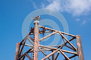 Men working at oil rig leg