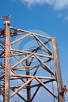 Men working at oil rig leg