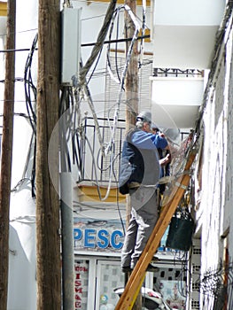 Men working on solving cabeling problem