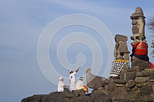 Men worshiping at Paben temple by the sea