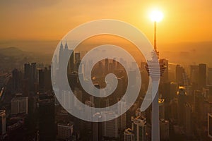 Menara Kuala Lumpur Tower with the sun. Aerial view of Kuala Lumpur Downtown, Malaysia. Financial district and business centers in