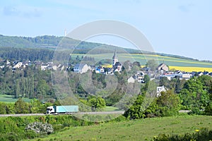 Mendig, Germany - 05 19 2021: A blue truck passing the B262 near Obemendig