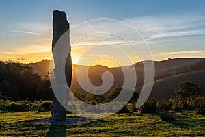 Menhir of Arlobi at sunset, Gorbea Natural Park, Alava, Spain photo