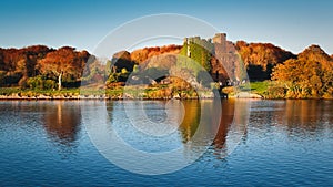 Menlo castle surrounded with autumn colored trees by the Corrib River at Galway City in Ireland