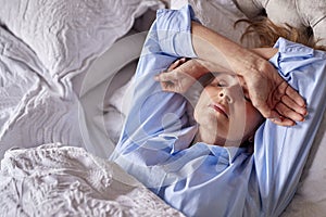 Menopausal Mature Woman Suffering With Insomnia In Bed At Home 