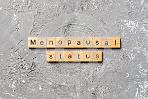Menopausal status word written on wood block. menopausal status text on cement table for your desing, concept