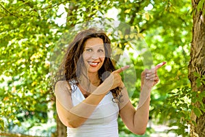 Menopausal woman points with index fingers on left