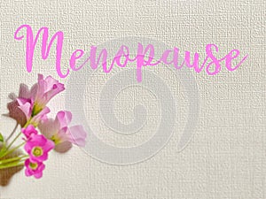 Menopause in pink colour on white background. Women health concept.