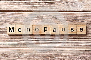 Menopause word written on wood block. menopause text on table, concept