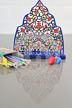 Menorah Dreidels and colorful candles on Hanukkah Jewish holiday