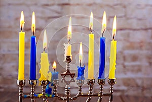 Menorah with candles for Hanukkah against defocused lights