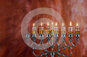 Menorah Hanukkah candles are burning in hanukkiah on light seven holiday day