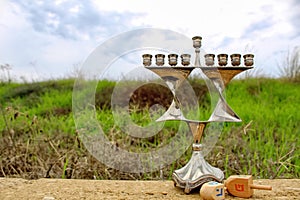 Menorah of Hanukkah. Jewish candlestick Menorah in style Jewish star Magen David and wooden toys Dreidels, Hanukkah holiday symbol