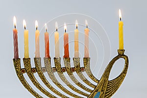 Menorah with lit candles in celebration of Chanukah. A symbolic candle lighting for the Jewish holiday