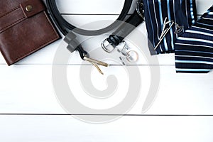 Mens accessories - wallet, belt, cufflinks, watch, tie clip, handkerchief and ring on white wooden background