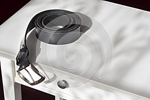 Mens belt on a bedstand