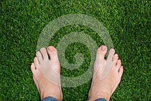 Mens feet standing on grass close up