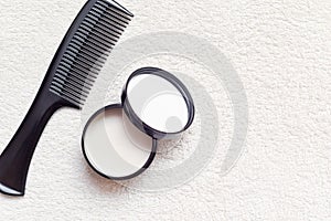 Mens hair product paste with black comb isolated on white background