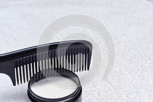 Mens hair product paste with black comb isolated on white background