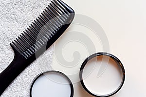 Mens hair product paste with black comb isolated on white background