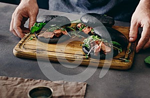 Mens hands holding hold wooden board burgers grilled meat