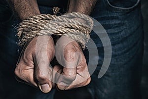 Mens hands tied with a rope. Concept of imprisonment in modern society