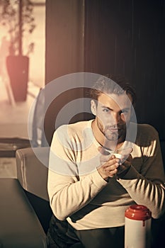 Mens heals body care. Man drink tea in teabowl from thermos