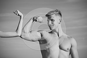 Mens heals body care. Man with strong hand biceps, triceps smile at female hand