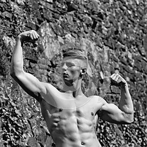 Mens heals body care. Muscular bodybuilder posing outdoor