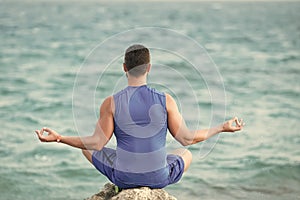 Mens heals body care. yogi having meditation at beach.