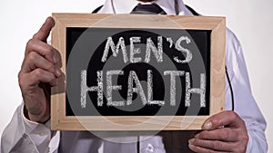 Mens health written on blackboard in urology doctor hands, reproductive medicine