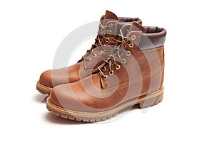 Mens leather brown waterproof boots for winter or autumn hiking isolated on white background. Mens fashion, trendy footwear. Close