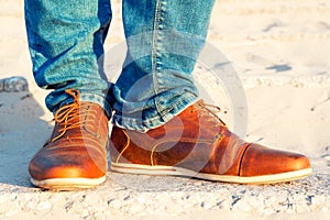 Mens legs in jeans and brown leather elegant luxury shoes.