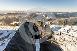 Mens legs in winter shoes against panorama over the Carpathian m