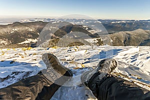 Mens legs in winter shoes against panorama over the Carpathian m