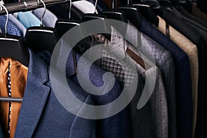 Mens suits on hangers in different colors