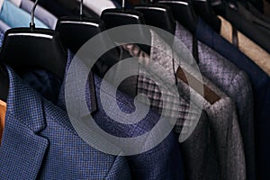 Mens suits on hangers in different colors