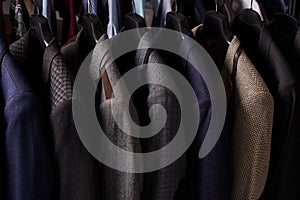 Mens suits on hangers in different colors