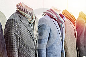 Mens tweed sport coats with scarves in clothing store