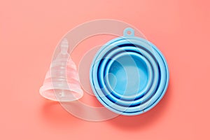 Menstrual cup isolated on pink background. Feminine health care product, reusable feminine hygiene product