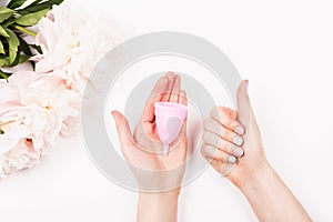 Menstrual cup in woman hands
